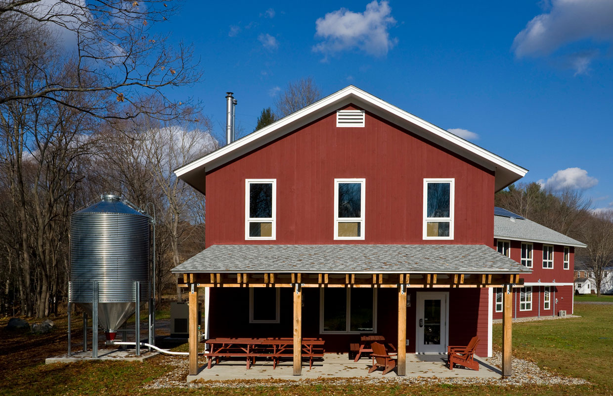 large red barn-style building with a cover porch