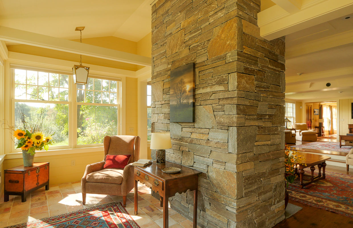 large stone chimney inside a great room with a reading nook
