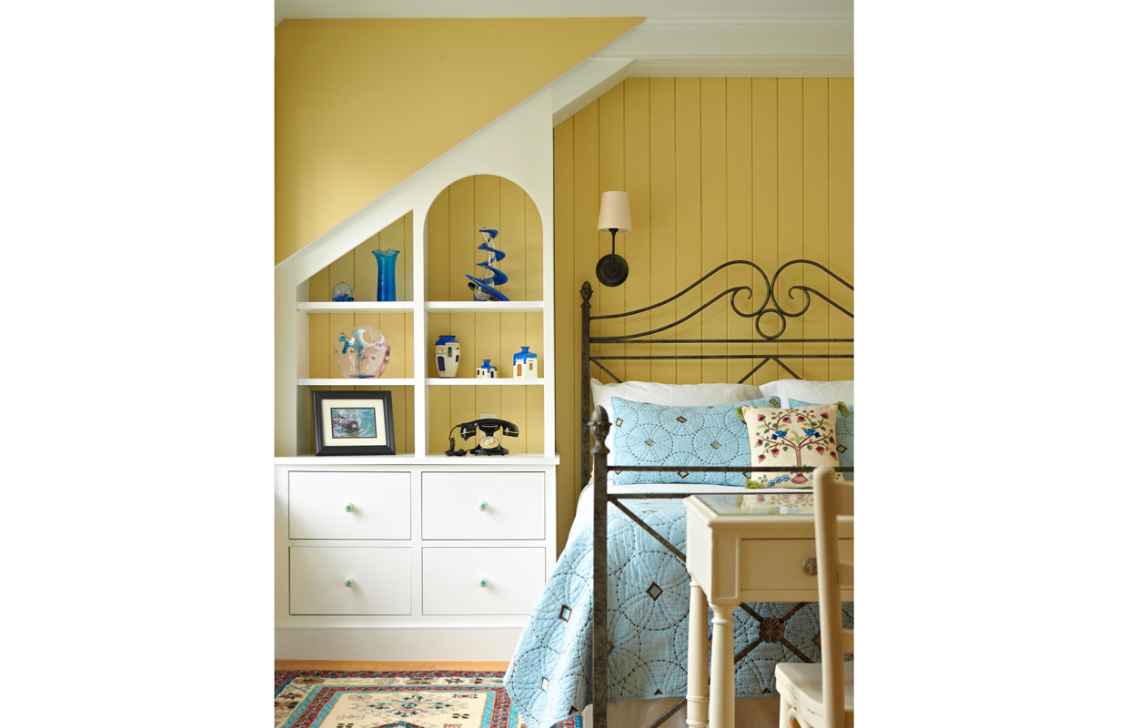 bedroom with yellow walls and a built-in bookshelf